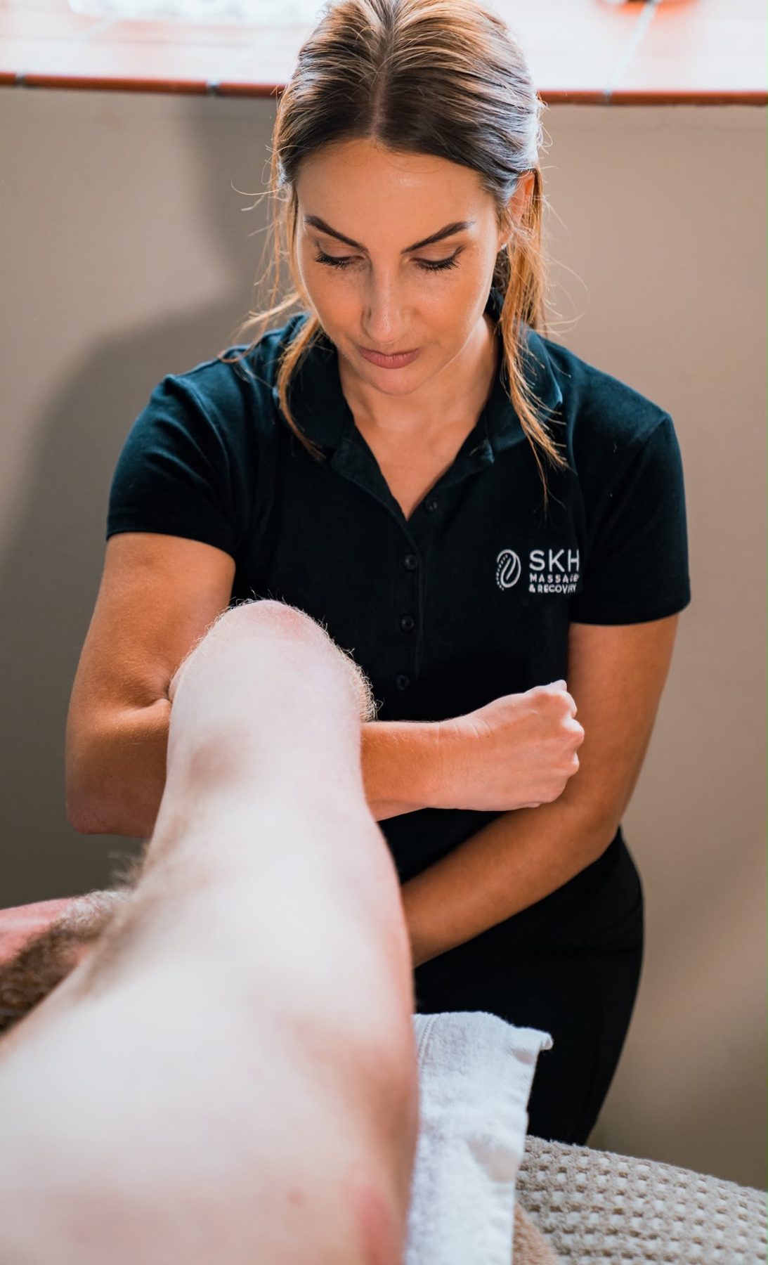 Sophie working on a client's leg